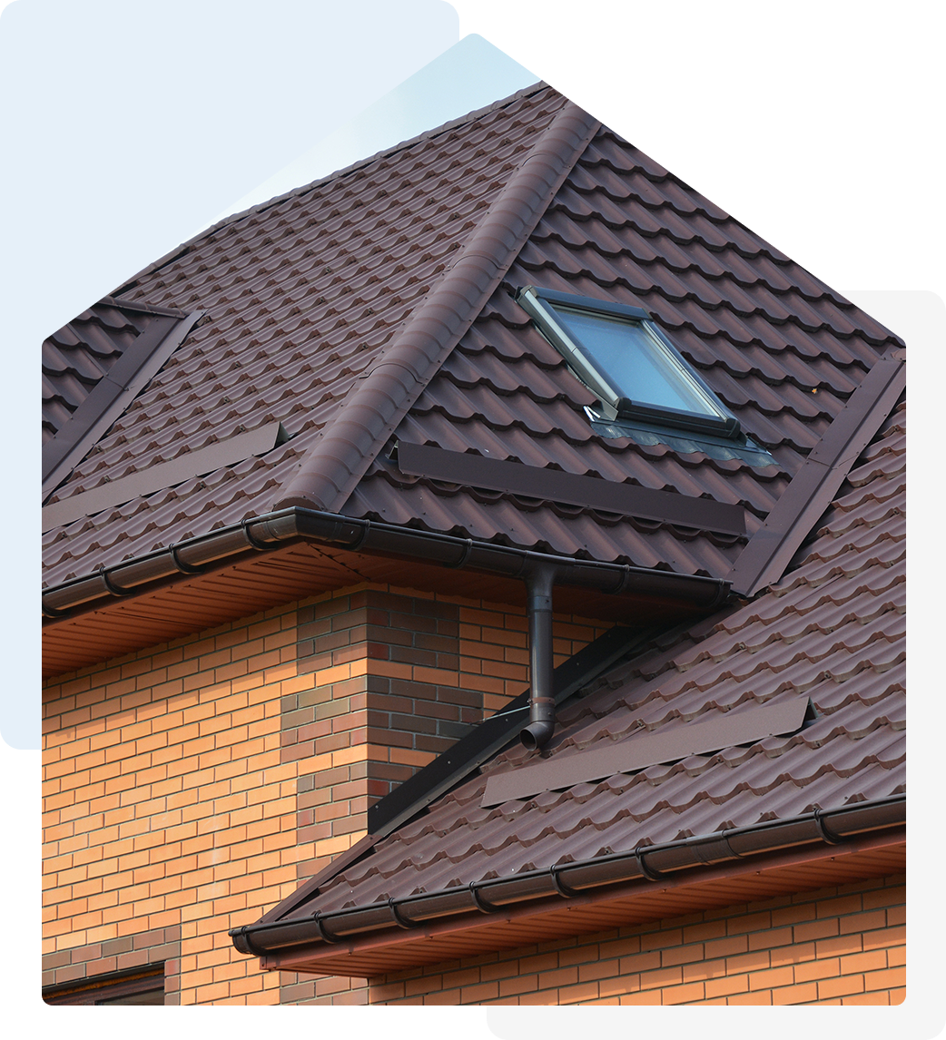 Brown roof shingles, brick house, skylight.